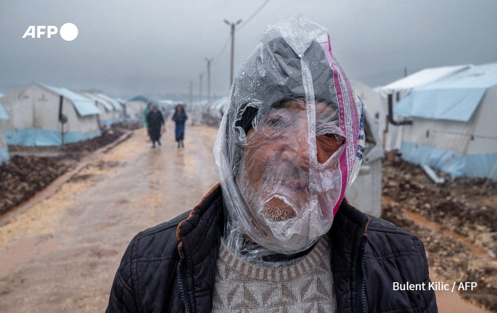 Man wears a plastic bag over his head to protect himself from the rain, Turkey